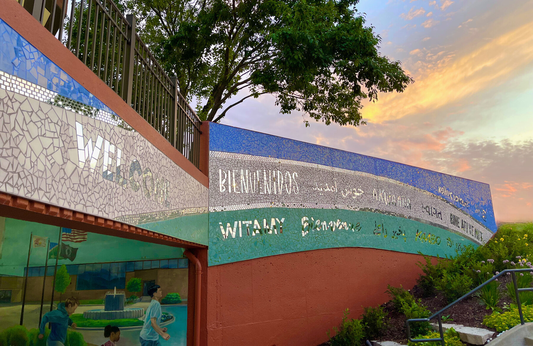 Photo showing a part of Allaina Humphreys's A Reflection of Bolingbrook mosaic at Village Hall, with the word for welcome in mirrored tile in 27 of the most-spoken languages in Bolingbrook